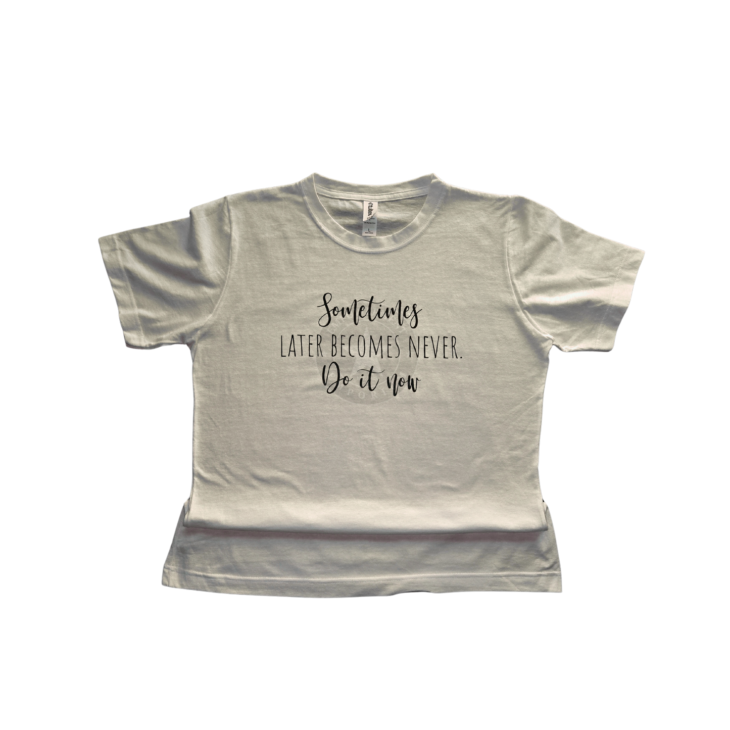Women’s fitted white t‑shirt with “Sometimes later becomes never — do it now” printed in dark green HTV.
